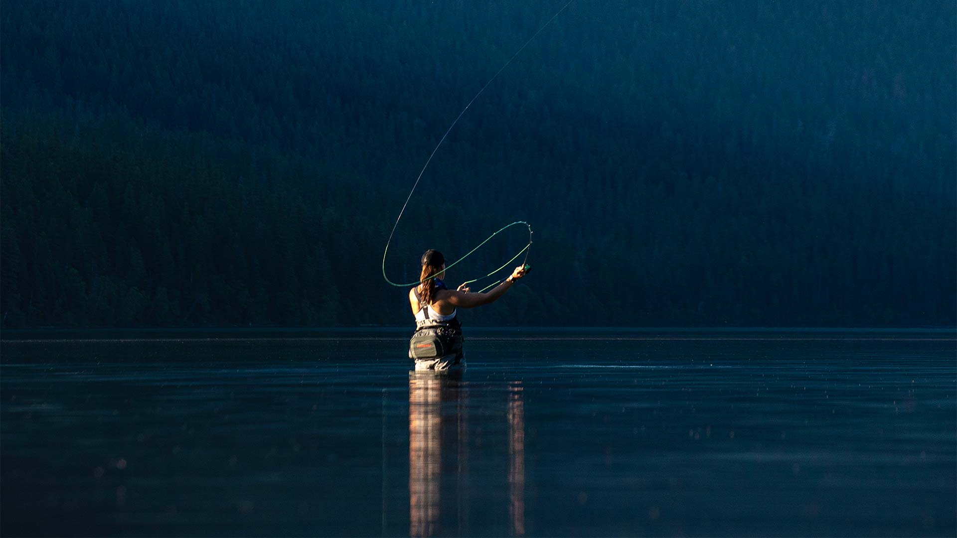 Jackson Hole Fly Company - Woman fly fishing in Glacier National Park, Montana - Photo: Ryan Dee