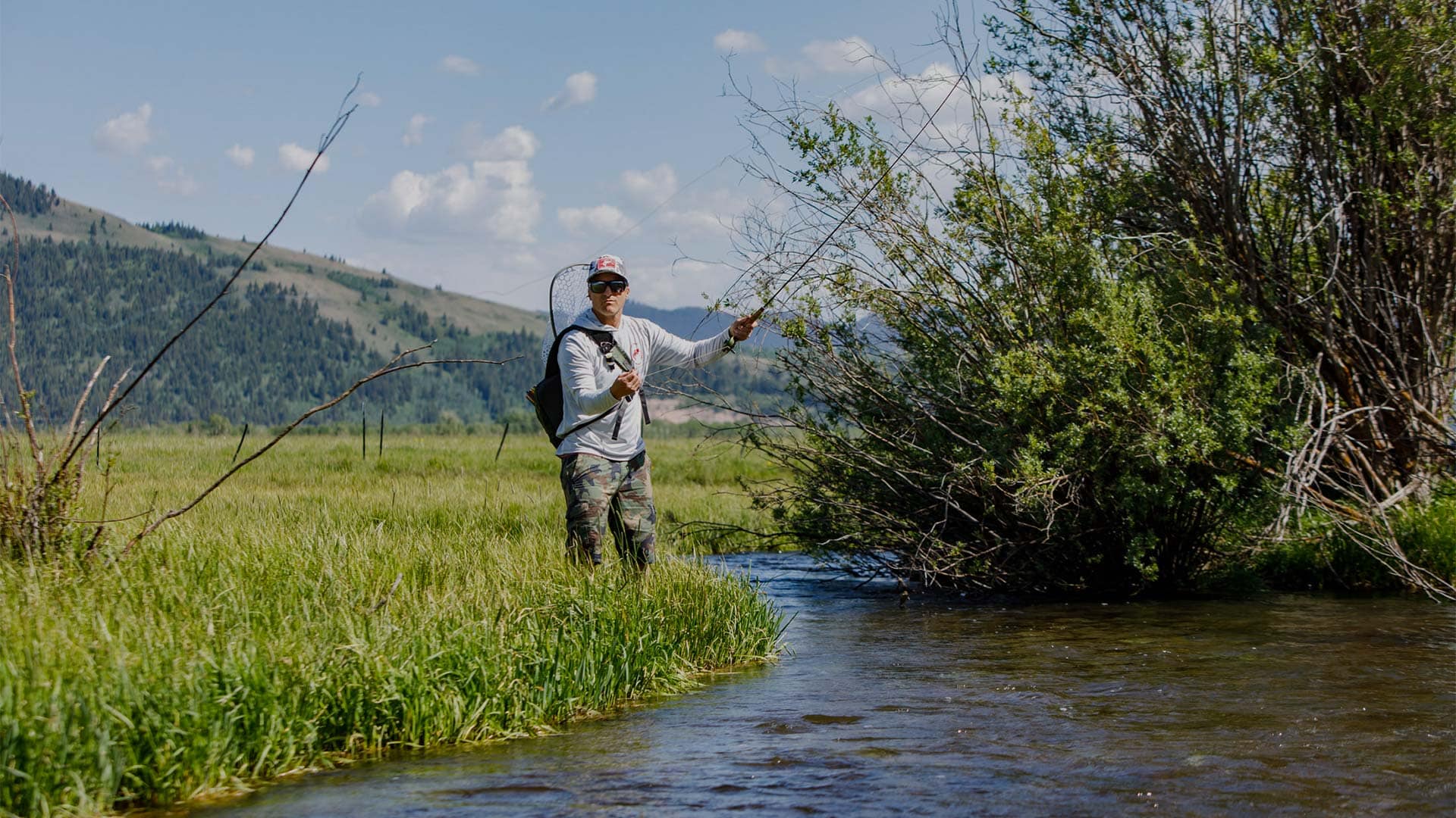 Man fly fishing on a creek in the Tetons near Jackson Hole, Wyoming. Photo by Mark Epstein