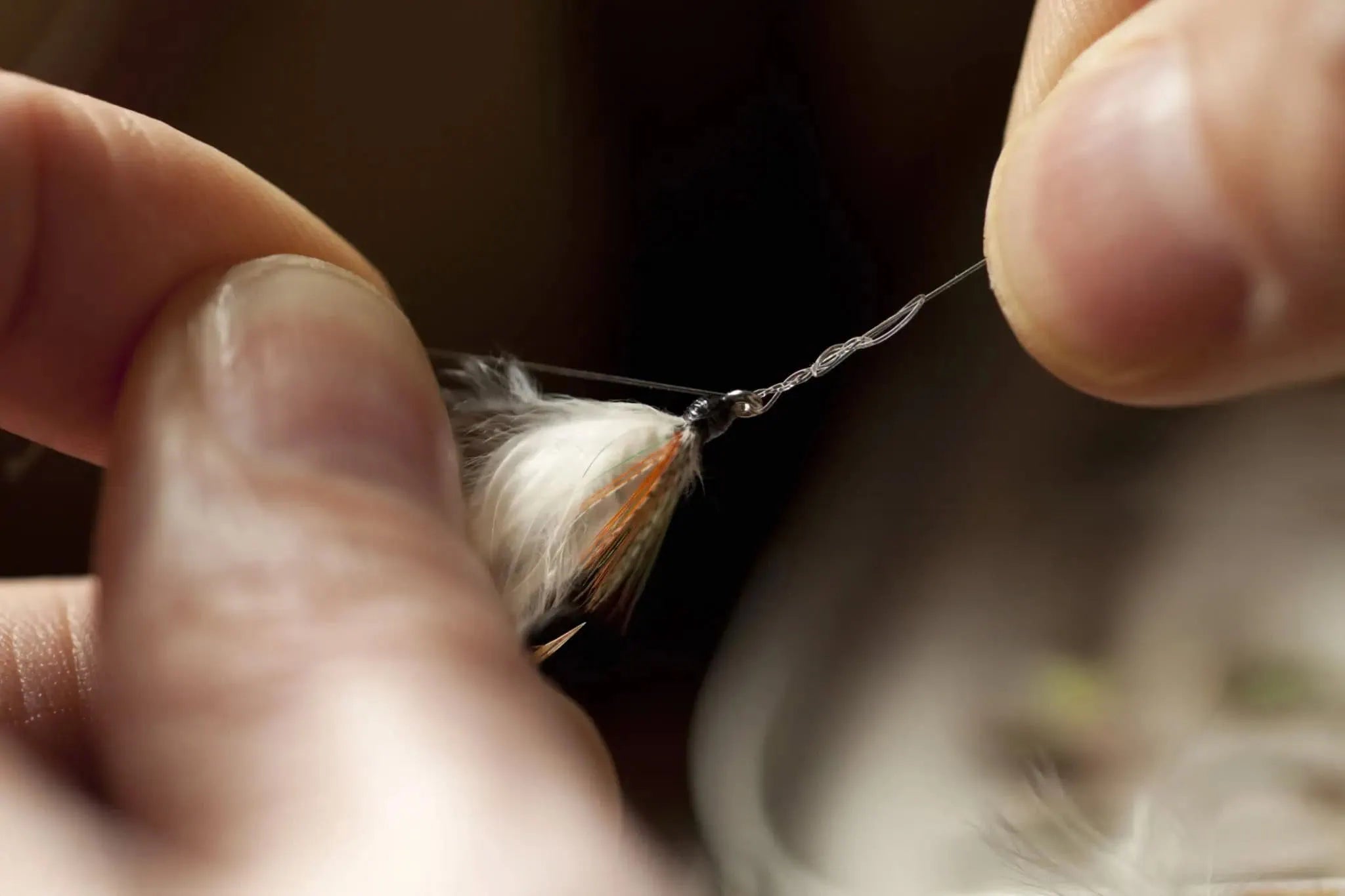 Hands practicing tying a fly fishing knot onto tippet material | Jackson Hole Fly Company