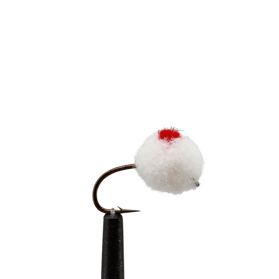 a white and red bird is sitting on a post 